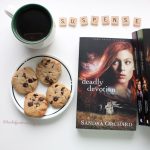 Image of Deadly Devotion by Sandra Orchard beside a cup of coffee and cookies