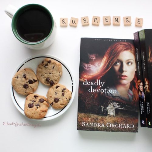 Image of Deadly Devotion by Sandra Orchard beside a cup of coffee and cookies